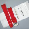 Achterkant van het Red MoonSwatch horlogebandje en verpakking van The Strap Brothers