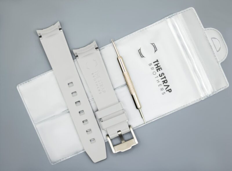 Back of the white MoonSwatch strap and packaging of The Strap Brothers