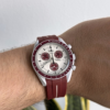 front view moonswatch pluto with red strap