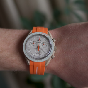 front view moonswatch jupiter with orange strap
