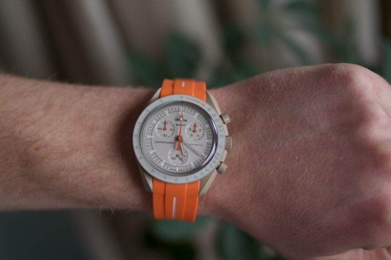 front view moonswatch jupiter with orange strap