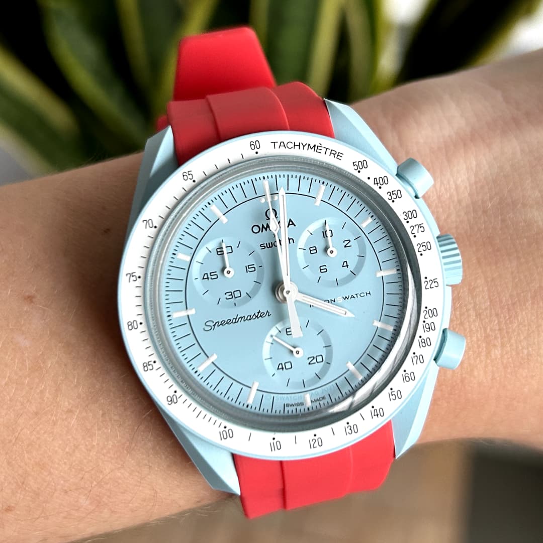 moonswatch uranus with red replacement strap